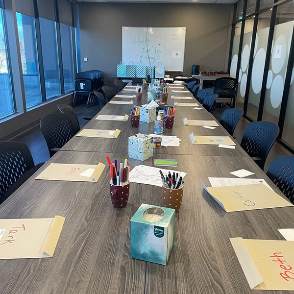 Volunteer Services program materials are arranged on the tables of the SACE boardroom along with gift bags and prepared activities for the fall SIL commencement.